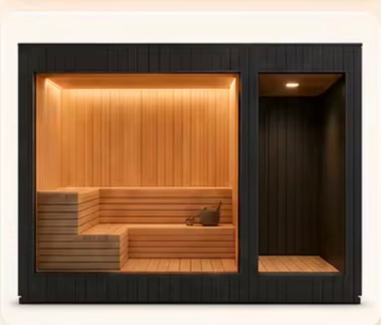 Sauna with tiered cedar benching alongside a separate changing area